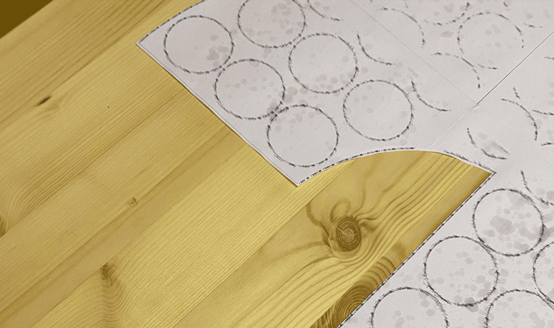 Paper templates printed with circle outlines glued onto pine boards, marking bulb positions for the sign
